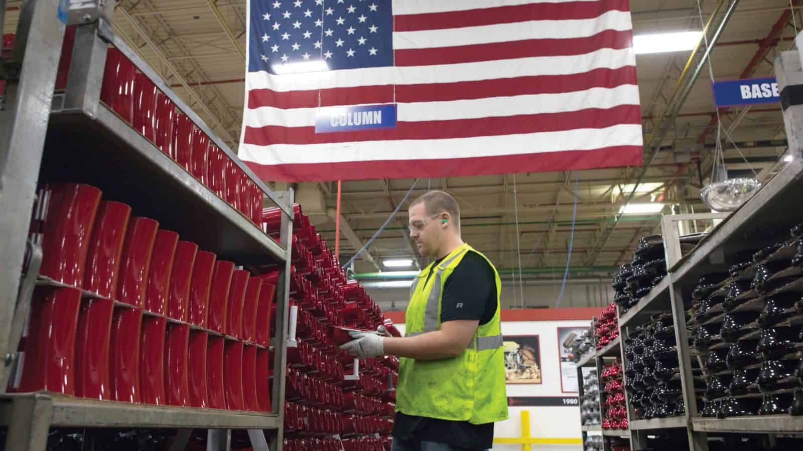 Manufacturing Worker With Flag in Background