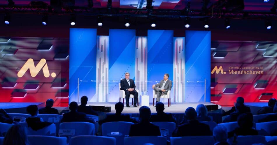 a group of people on a stage in front of a crowd